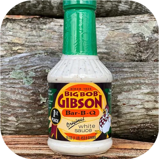 A single bottle of Big Bob Gibson Original White Sauce against a wood background.