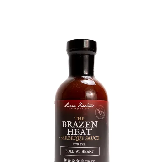 A bottle of Bone Doctors' The Brazen Heat barbeque sauce against a white background.