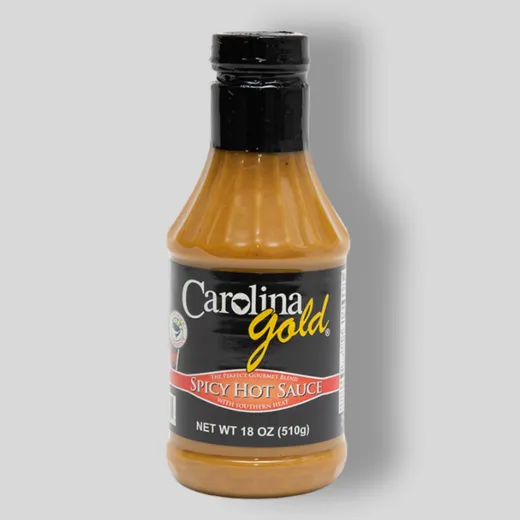 A single bottle of Carolina Gold Spicy Hot Sauce against a plain background.