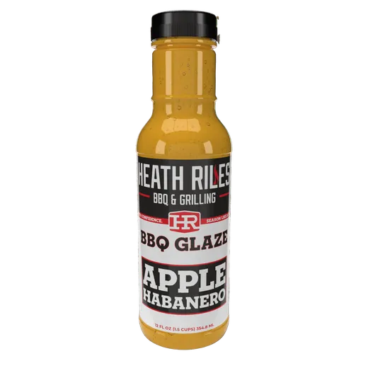 A bottle of Heath Riles Apple Habanero BBQ Glaze on a black background.