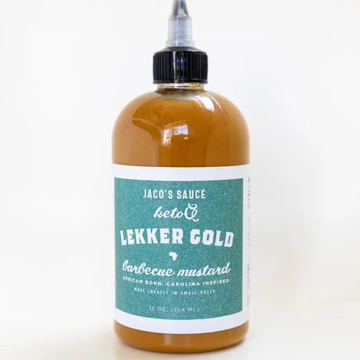 A close-up of a single bottle of Jaco's Sauce Lekker Gold barbecue mustard.
