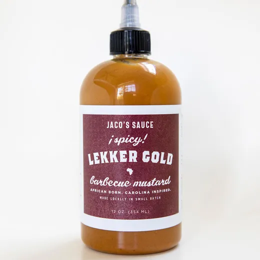 A bottle of Jaco's Sauce Lekker Gold barbecue mustard on a white background.