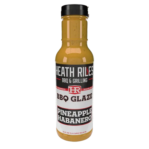 A bottle of Heath Riles BBQ Glaze Pineapple Habanero standing on a white background.